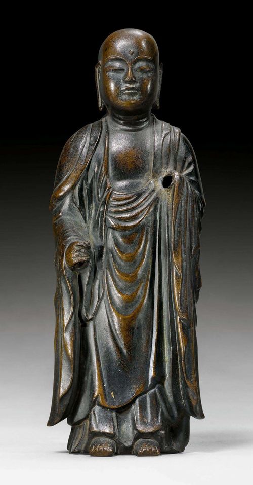 A BRONZE FIGURE OF THE STANDING JIZÔ. Japan, Edo period, height 27.5 cm. Inscription on the back. One hand and staff missing.