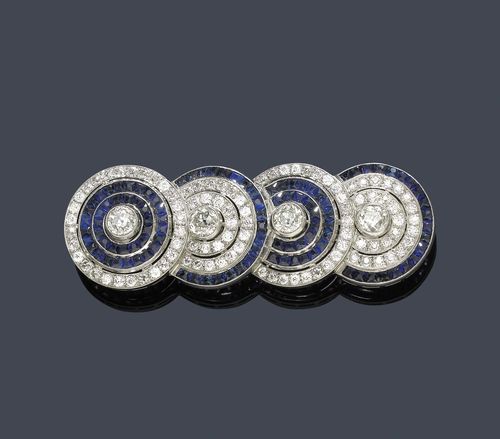 SAPPHIRE AND DIAMOND BROOCH, TIFFANY & Co, ca. 1920. Platinum. Very fancy brooch designed as 4 circle motifs stacked on top of one another, set with 4 old European-cut diamonds weighing ca. 3.20 ct and set throughout with 99 old European-cut diamonds weighing ca. ca. 4.90 ct and 105 square-cut sapphires weighing ca. 4.00 ct. Signed Tiffany & Co. Pin in white gold 750. Ca. 6.3 x 2 cm. With ÖGV Report No.  A-011P055VR/R, July 2011.
