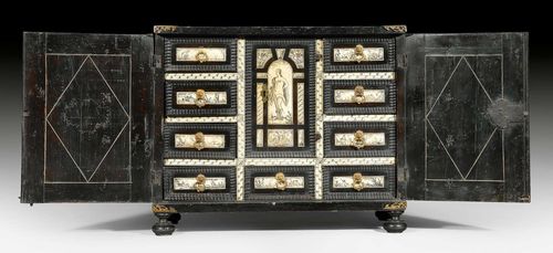 SMALL CABINET,Renaissance, northern Italy, 17th century. Ebonized wood with fine, engraved bone inlays. The front with double doors. The interior with large central door above drawer, flanked on each side by 4 drawers. With 2 adjacent drawers above a large compartment inside. Partly lined with old paper. Bronze mounts and drop handles. 58x32x42 cm.