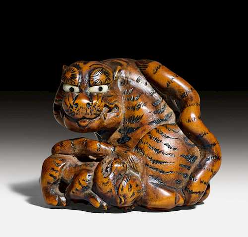 NETSUKE OF A SEATED TIGER AND CUB.