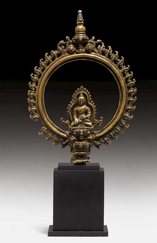 A BRONZE FITTING WITH BUDHA IN AN AUREOLE.