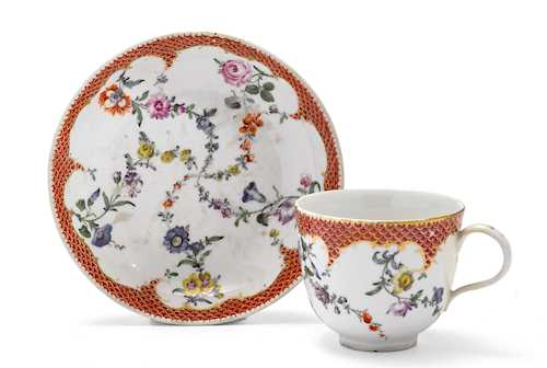 A CUP AND SAUCER WITH MOSAIC BORDER