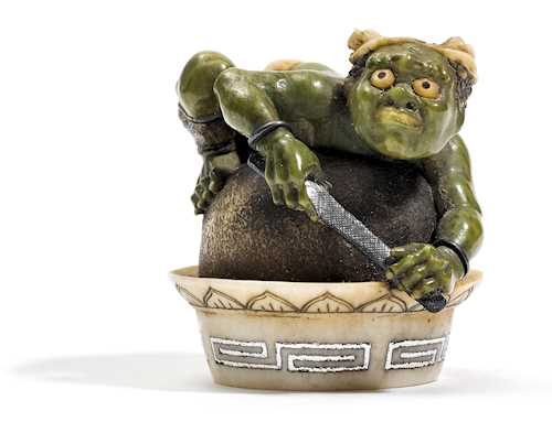 A STAINED NETSUKE OF AN ONI.