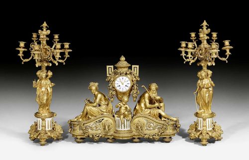 IMPORTANT MANTEL SET,Louis XVI style, the bronze from a Paris master workshop, probably after designs by V. PAILLARD (Victor Paillard, 1805-1886), the dial inscribed LENOIR A PARIS, circa 1870. Gilt bronze and white marble. The clock with enamel dial with blue Roman hour numerals and Arabic minute numerals, as well as French weekdays, Arabic month days and planet symbols. 4 fine gilt hands. Paris escapement striking the ½ hours on bell. The candelabra with 7 light branches on 2 levels. Rich gilt mounts and applications Some losses. The clock requires servicing. Clock: 87x26x68 cm. Candelabra: H 94 cm.