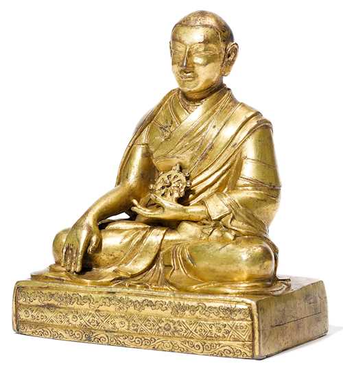 A GILT COPPER ALLOY FIGURE OF A HIGH RANKING MONK.