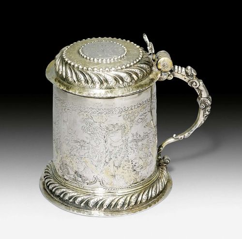 TANKARD WITH COVER,probably Germany circa 1700. With maker’s mark. Parcel gilt, embossed, chased and engraved. Finely engraved on all sides with Nativity depictions. The lid with engraved medallion with the Annunciation. Curved handle with herm and angel thumbpiece (damaged). H 15 cm, 440 g.
