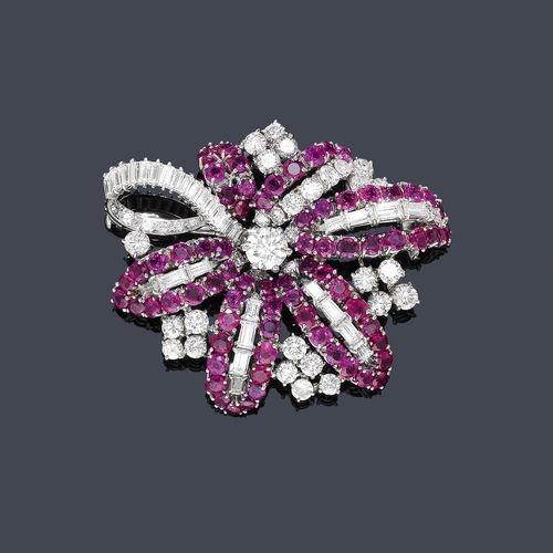 RUBY AND DIAMOND BROOCH, ca.  1950. Platinum 950. Classic-elegant brooch designed as a stylized flower, set with 1 brilliant-cut diamond of ca. 0.60 ct, 74 rubies weighing ca. 7.00 ct, 32 navette-cut diamonds weighing ca. 2.00 ct and 36 brilliant-cut diamonds weighing ca. 1.50 ct. Pin in white gold.
