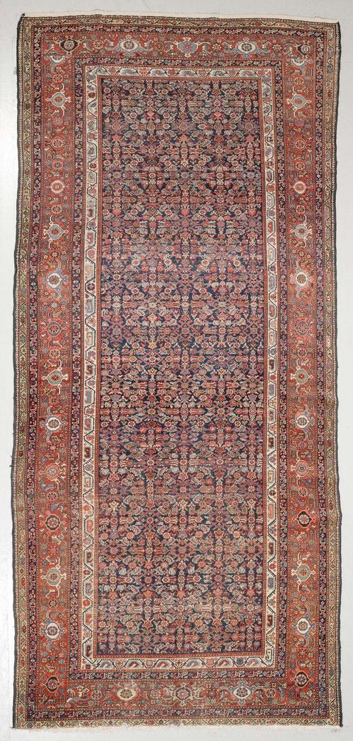 HAMADAN antique.Dark blue central field patterned throughout with stylized plant motifs, red edging with tendrils, strong signs of wear, 195x405 cm.