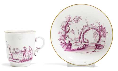 A CHOCOLATE CUP AND SAUCER WITH PURPLE LANDSCAPES,
