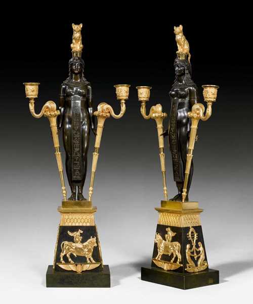 PAIR OF IMPORTANT CANDELABRA "AUX EGYPTIENNES",Empire, from a Paris master workshop, after designs by C. PERCIER (Charles Percier, 1764-1838), circa 1805/10. Burnished bronze with matte and polished gilt bronze. Modifications to the cat figures. H 67 cm. Provenance: Sotheby's London auction, 9.7.2009 (Lot No. 43).