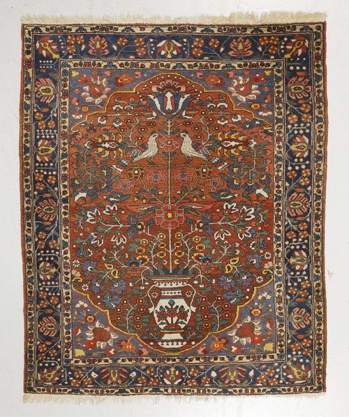 BACHTIAR old.Red ground with blue corner motifs, patterned with vases and birds, blue border with trailing flowers, 168x197 cm.