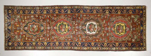 BACHTIAR antique.Red ground with four floral medallions, blue border, 135x445 cm.