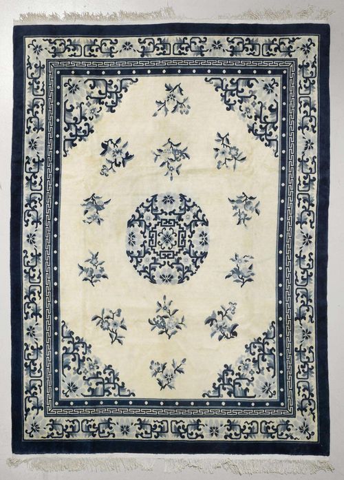 CHINA old.Beige ground with a central medallion. The entire carpet is patterned with floral motifs. Beige edging. Slight wear. 245x305 cm.