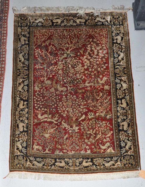 GHOM SILK old.Dusky pink central field finely patterned with plants and animals, black border, 105x158 cm.