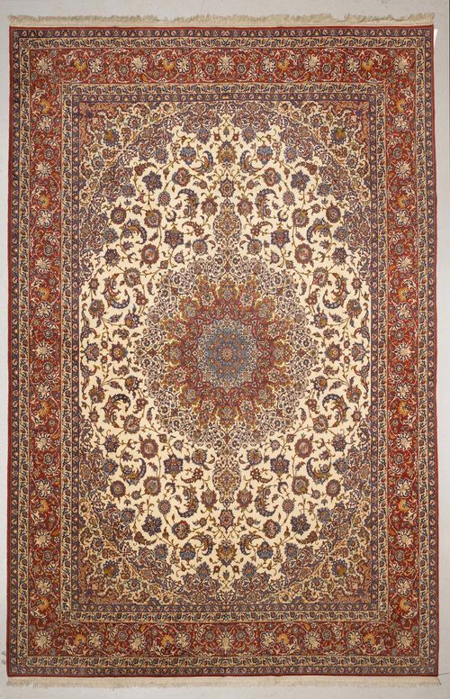 ISFAHAN old.White central field with a red central medallion and beige corner motifs, finely patterned with trailing flowers and palmettes, red edging with trailing flowers, 315x435 cm.