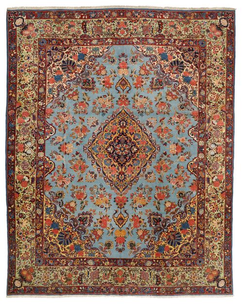 KESHAN old.Light blue central field with a yellow central medallion and corner motifs, the entire carpet is finely patterned with floral motifs in delicate pastel colours, light green edging, in good condition, 295x375 cm.