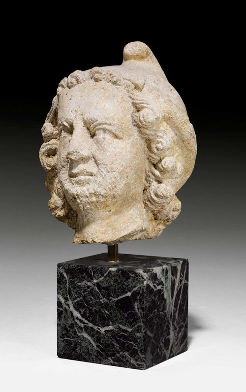 HEAD OF A MAN,Roman, Italy. Limestone. Representation of a bearded barbarian with a Phrygian cap. On a "Vert de Mer" plinth. H (with plinth) 29 cm.