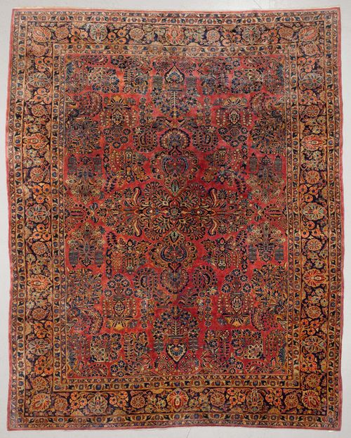 SARUK old.Dusky pink central field, opulently patterned with floral motifs in blue and yellow, dark blue edging with trailing flowers and palmettes, in good condition, 270x363 cm.