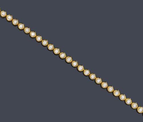 DIAMOND BRACELET. Yellow gold 750, 24g. Casual-elegant Rivière bracelet, set with 32 brilliant-cut diamonds weighing ca. 1.20 ct, in half-spherical prong settings, L ca. 17.5 cm. Matches the previous lot.