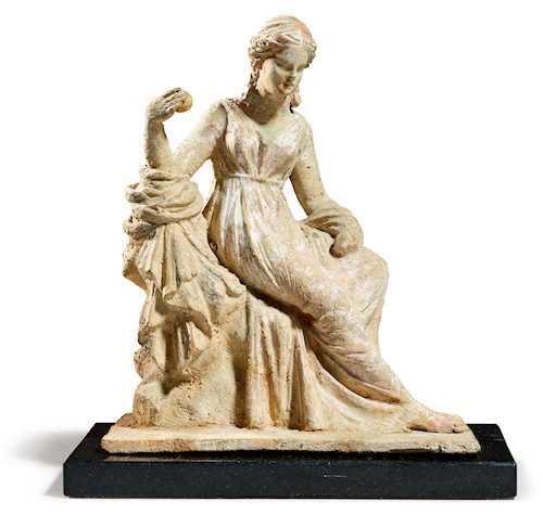 SITTING MUSE HOLDING AN APPLE IN HER HAND, a so-called "Tanagra figurine"