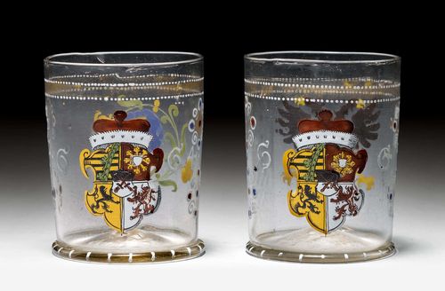 PAIR OF GLASS BEAKERS WITH THE ELECTORAL SAXONIAN COAT-OF-ARMS,Saxony, dated 1664. Cylindrical shape. Polychrome enamelled paint with four-part Saxon coat-of-arms on the front, the back of one beaker with an Imperial eagle, the other beaker with an individual flower. Surrounding gold band with white dotted border on the upper edge. H 8.5 cm. (2)