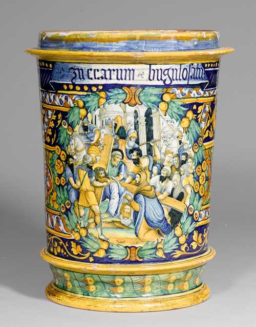 IMPORTANT, LARGE 'MAJOLICA' PORCELAIN 'ISTORIATO' ALBARELLO ,  'A QUARTIERI', Faenza, ca. 1540-1550. Cylindrical, slightly conical vessel with circumferential profiled rings on the top and on the bottom. The front with a scene from the Stations of the Cross, depicting Christ on his way to Golgotha. at the moment he stumbles and Saint Veronica hands him the sudarium (sweat-cloth) which already shows the features of Christ. The scene takes place in a crowd of Roman soldiers, with an antique cityscape in the background. Framed by a green laurel wreath with yellow fruit, on a background of tendril borders with grotesque figures in blue, yellow and green in the 'Quartieri' style. The top of the scene is adorned by an inscription accentuated in blue: 'ZUCCARUM BUGULOSATUM'. Remains of old provenance labels 'Collection Scalea'. H 48.5 cm, D 32 cm. Small repairs and some chipping of the glaze. Provenance: - Collezione dei Principi Lanza di Scalea, Palermo. - Private collection, Rome. 'Zuccarum buglosatum' means 'candied ox tongue' (Rudolf E.A. Drey, Apothecary Jars, 1978, page 238). This scene goes back to a series of woodcuts with depictions of the 'Passion of Christ' by Girolamo de Grandi from 1538, a copy of which must have been available to the artist in the majolica workshop, such as the one from the British Museum (see image). (Our special thanks goes to Dr. Stefanie Meier-Kreiskott for pointing out this example to us.) Both of these Albarelli are exceptional pieces of art and are part of a group of important large Albarelli 'istoriati' in the Faenza  'a quartieri' style. This type of decoration is typical for the Faenza workshops, and can be substantiated by two apothecary jars in the Louvre in Paris, signed 'FATE IN FAENZA' . (C. Ravanelli Guidotti, Thesaurus di opere della tradizione di Faenza, Faenza 1998, page 391). A comparable Albarello from this series, from Faenza, by Baldassare Manara, with a depiction of the Holy Family, formerly from the collection of M.P. Botkin in Petrograd, is presently in the Hermitage Museum in Saint Petersburg (Inv.No. F 2133). (Ivanova E., Il secolo d'oro della maiolica. Ceramica italiana dei secoli XV-XVI dalla raccolta del Museo Statale dell' Ermitage, 2003, page 42 No.10). For further majolica porcelain attributed to Baldassare Manara, see Ravanelli Guidotti, Baldassare Manara faentino, pittore di maioliche nel Cinquecento, Ferrara, 1996, page 194. In 1999, Giuliana Gardelli attributed a group of majolica porcelain with a similar decoration to the workshops of Guido da Merlino and Guido Durantino from Urbino. (Italika, Maiolica Italiana del Rinascimento, 1999, pages 258-260, No. 111). CHF 90 000.- / 120 000.- € 75 000.- / 100 000.-