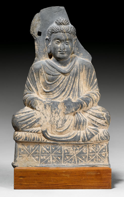 A GREY SCHIST FIGURE OF THE SEATED BUDDHA WITH REMAINS OF A HALO.