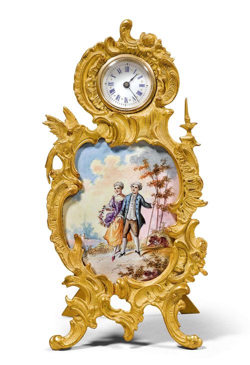 ENAMEL TABLE CLOCK, ca. 1890. Brass. Decorative, asymmetrical table clock, with a curved frame and curvy feet. In the centre, a polychrome enamelled plate with a gallant scene and a landscape background. The top decorated with volutes and flowers, and with 1 small round clock with enamelled dial, Roman numerals in blue, and blued hands. Ca. 12.5 x 5.8.