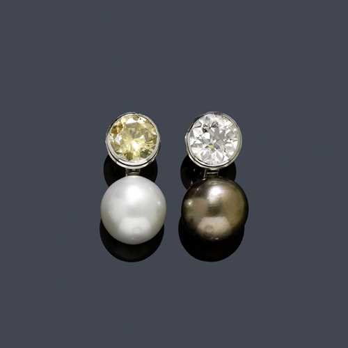 PEARL AND DIAMOND EAR PENDANTS, HEMMERLE. Platinum, mechanical part in white gold 750. Very fancy ear clips, one with 1 aubergine-coloured Tahiti cultured pearl of ca. 16.6 mm Ø, flexibly mounted underneath 1 old European cut diamond weighing ca. 6.50 ct, ca. J/SI2, in a collet setting, and one with 1 white South Sea cultured pearl of ca. 16.4 mm Ø underneath 1 fancy-brown brilliant-cut diamond weighing ca. 5.50 ct, ca. SI1, in a collet setting. With original case. Oral estimate by GGTL/Gemlab.