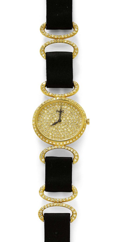 DIAMOND LADY'S WRISTWATCH, PIAGET, 1980s. Yellow gold 750. Ref. 9802DB. Oval case No. 342930 with diamond lunette and attaches. Dial pavé-set with numerous single-cut diamonds, black hands, signed on the glass. Hand winder, ultra-flat movement No. 7907940, Cal. 9P2, with gold pallet and gold escapement wheel, signed. Black, satin-finished band with diamond-set intermediate rings and clasp. D 27 x 23 mm.