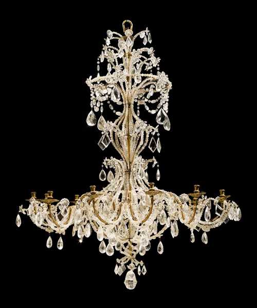 IMPORTANT CHANDELIER WITH "CRISTAL DE ROCHE",Louis XV, Genoa circa 1760. Shaped and gilt bronze and wood with exceptionally fine cut glass and crystal hangings. With 12 light branches. D 125 cm, H 160 cm.