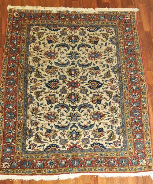 GHOM old.The white central field is patterned throughout with trailing flowers and palmettes. With a red border. Slightly worn, 140x210 cm.