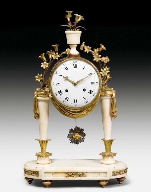 PORTAL CLOCK,Louis XVI, France, late 18th century. White marble and gilt bronze. Bronze applications in the form of flowering branches, drapery and decorative frieze (incomplete). White enamel dial (chipped).  Paris escapement inscribed FRF 369 with 1/2 hour striking on bell. H 45 cm. Back feet replaced, some restoration required.