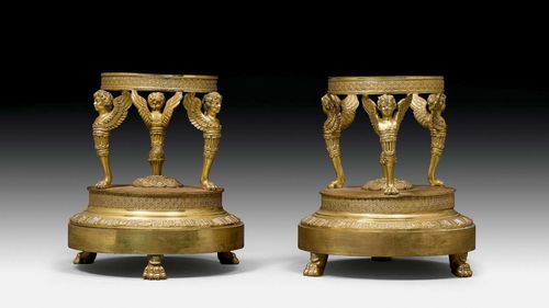 PAIR OF TABLE ORNAMENT PLINTHS,late Empire, Paris, 19th century. Relief-decorated and chased gilt bronze. Ring-shaped holder for bowl (missing). H 18 cm.