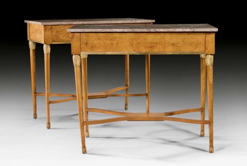 PAIR OF CONSOLE TABLES, Biedermeier, Northern Germany, circa1830/40. Ash and mahogany carved with leaves and parcel gilt. Beige, black speckled granite top. 107 x 60 x 92 cm. The stretcher supplemented. Provenance: Derneburg Castle, Hildesheim district, Germany.