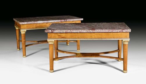 PAIR OF CENTER TABLES,Biedermeier, Germany, circa 1830. Relief-carved and gilt walnut. Violet/grey speckled marble top.  The cross-stretcher later. 88 x 146 x 80 cm. Scratches. Provenance: Derneburg Castle, Hildesheim district, Germany.
