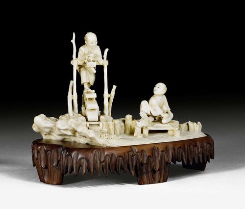 AN IVORY OKIMONO OF A PAESANT ON A WATER WHEEL. Japan, Meiji period, height 12 cm.