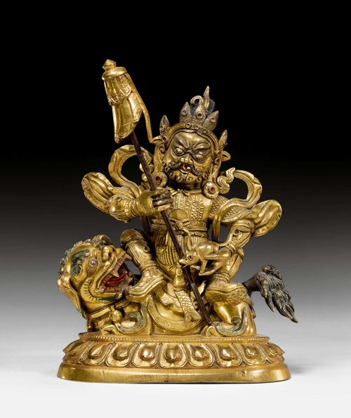 A GILT BRONZE FIGURE OF VAISHRAVANA SEATED ON HIS LION. Tibeto-chinese, around 1800. Height 15,5 cm. Base plate lost.