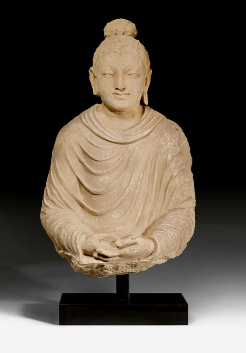 A STUCCO BUST OF BUDDHA. Gandhara, 3th/4th c. Height 49 cm. Metal stand. Chips.
