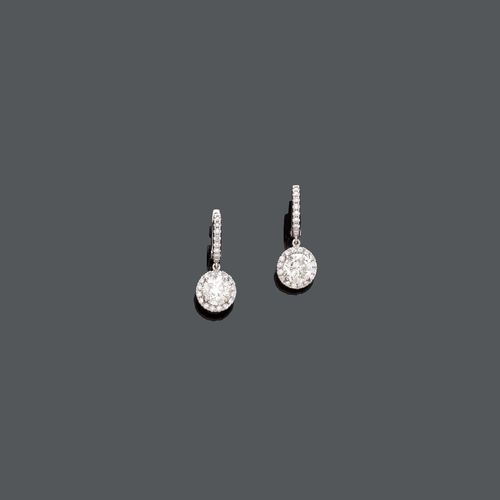 DIAMOND HOOP EARRINGS. White gold 750. Each suspending a movable diamond pendant of ca. 1.00 ct, ca. J-K/SI2-P1, within a brilliant-cut diamond surround, weighing ca. 0.30 ct.