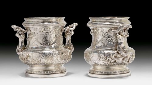 PAIR OF HISTORIC BOTTLE COOLERS,probably Hanau, 19th century. After a design by Juste-Aurèle Meissonnier. Round base. The walls opulently decorated with mythological scenes featuring Neptune. Chased cartouches, floral festoons and crowns. H 25 cm, total weight 4380 g.
