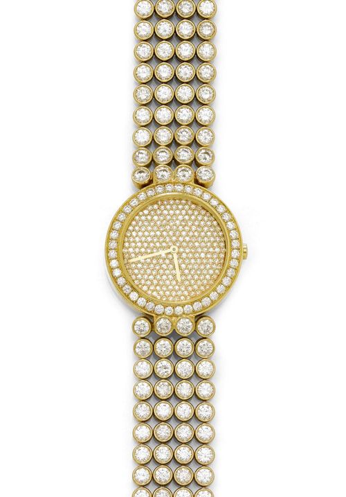 DIAMOND LADY'S WRISTWATCH, HARRY WINSTON, 1990s. Yellow gold 750. Numbered series. Round case No. 2310 with brilliant-cut diamond lunette. Dial set throughout with numerous brilliant-cut diamonds, gold-coloured baton hands. Quartz movement, signed. Four-row brilliant-cut diamond bracelet with 132 brilliant-cut diamonds and fold-over clasp. Total weight of the brilliant-cut diamonds ca. 22.00 ct. L ca. 17.2 cm. D 30 mm.