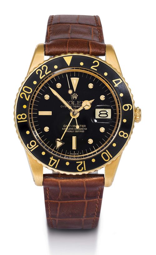 EARLY ROLEX GMT MASTER, GENTLEMAN&#39;S WRISTWATCH, 2 TIME ZONES, 1960s. Yellow gold 750. Ref. 1675. Tonneau-shaped, matte-finished and polished case No. 900 029 with Plexiglas, screw-down back and crown without crown protection (one of the early designs), bi-directionally rotatable lunette with black / gold 24 hour division. Black dial with applied luminous indices and luminous hands. Signed Rolex Oyster Perpetual GMT-Master. Date at 3h, 24h hand extending from the centre. Rhodium-plated automatic movement Cal. 1565. Brown leather band with gold-plated clasp. D 39.5 mm.