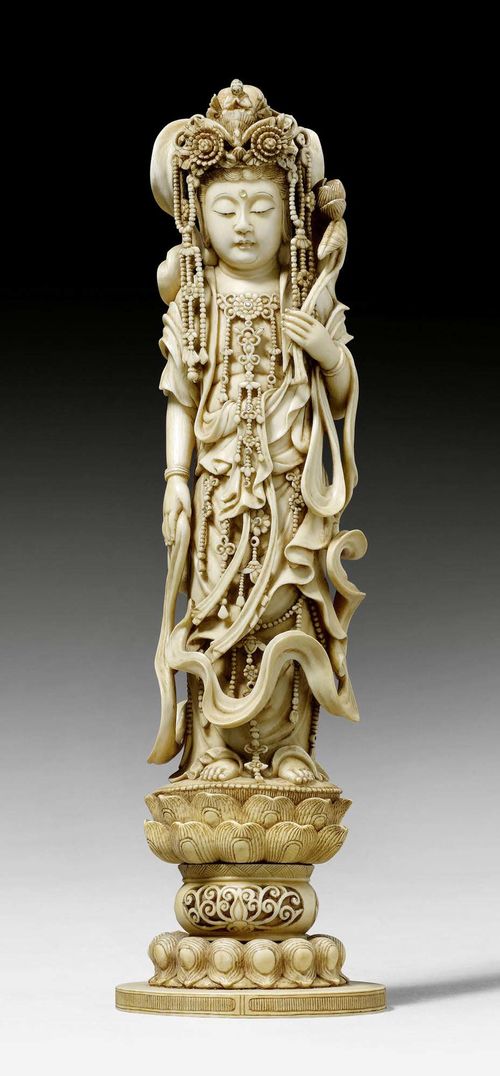 AN IVORY OKIMONO OF A STANDING GODDESS. Japan, Meiji period, height 29.5 cm. Signed. Base crack.