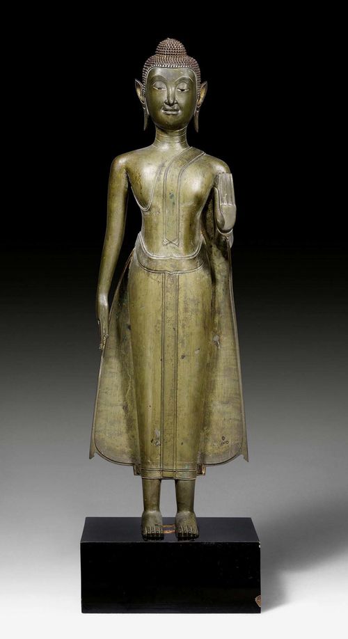 A SLENDER BRONZE FIGURE OF THE STANDING BUDDHA. Thailand, circa 17th c. Height 88 cm. Lacquer gilding and Ketumala lost.