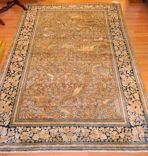 ISFAHAN antique.Central field in dusky pink, finely patterned with a tree of life and depictions of animals in attractive pastel colours, black border with trailing flowers, good condition, 142x240 cm.
