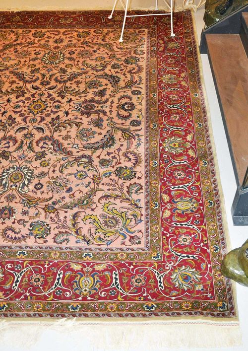 TABRIZ old.Pink central field patterned throughout with trailing flowers and palmettes, red border, slight wear, 255x335 cm.