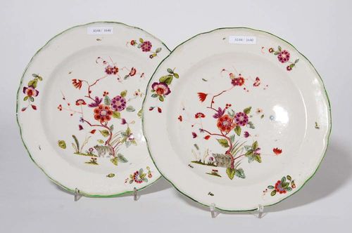 PAIR OF PLATES WITH KAKIEMON DECORATION, Frankenthal, Paul Hannong, 1755-59.Each plate with a spray of Indianische Blumen. Underglaze blue rampant lion, PH impressed mark. D 24cm. The edges with small restorations.
