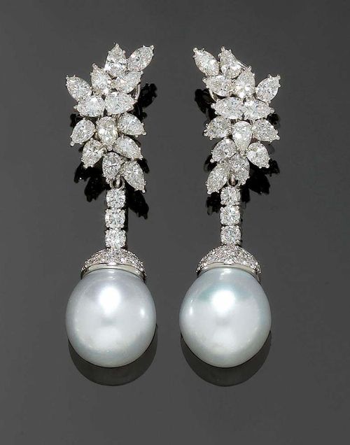 DIAMOND AND PEARL PENDANT EARRINGS, ca. 1950. White gold 750. Very elegant, attractive clip earrings. The leaf-shaped clip parts set with 14 diamond drops totalling ca 5.40 ct, the removable mounted end pieces set with 1 fine South Sea cultured pearl of ca. 15.3 x 16. 4 on a brilliant-cut diamond setting suspended by a row of 3 brilliant-cut diamonds. Total diamond weight ca. 2.35 ct. L ca. 5.4 cm