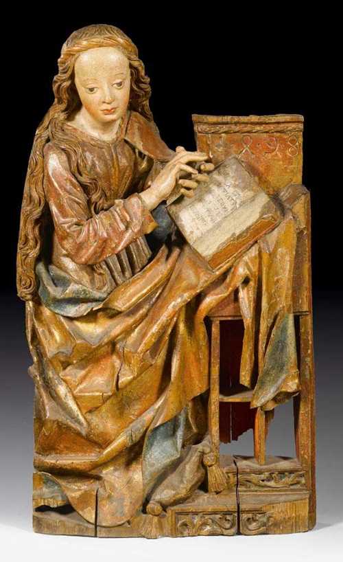 MARY FROM AN ANNUNCIATION GROUP,late Gothic, Franken, probably  Nuremberg, dated 1498. Carved linden wood, flat verso, painted and parcel gilt. H 104 cm. A finger and the paint partly restored.